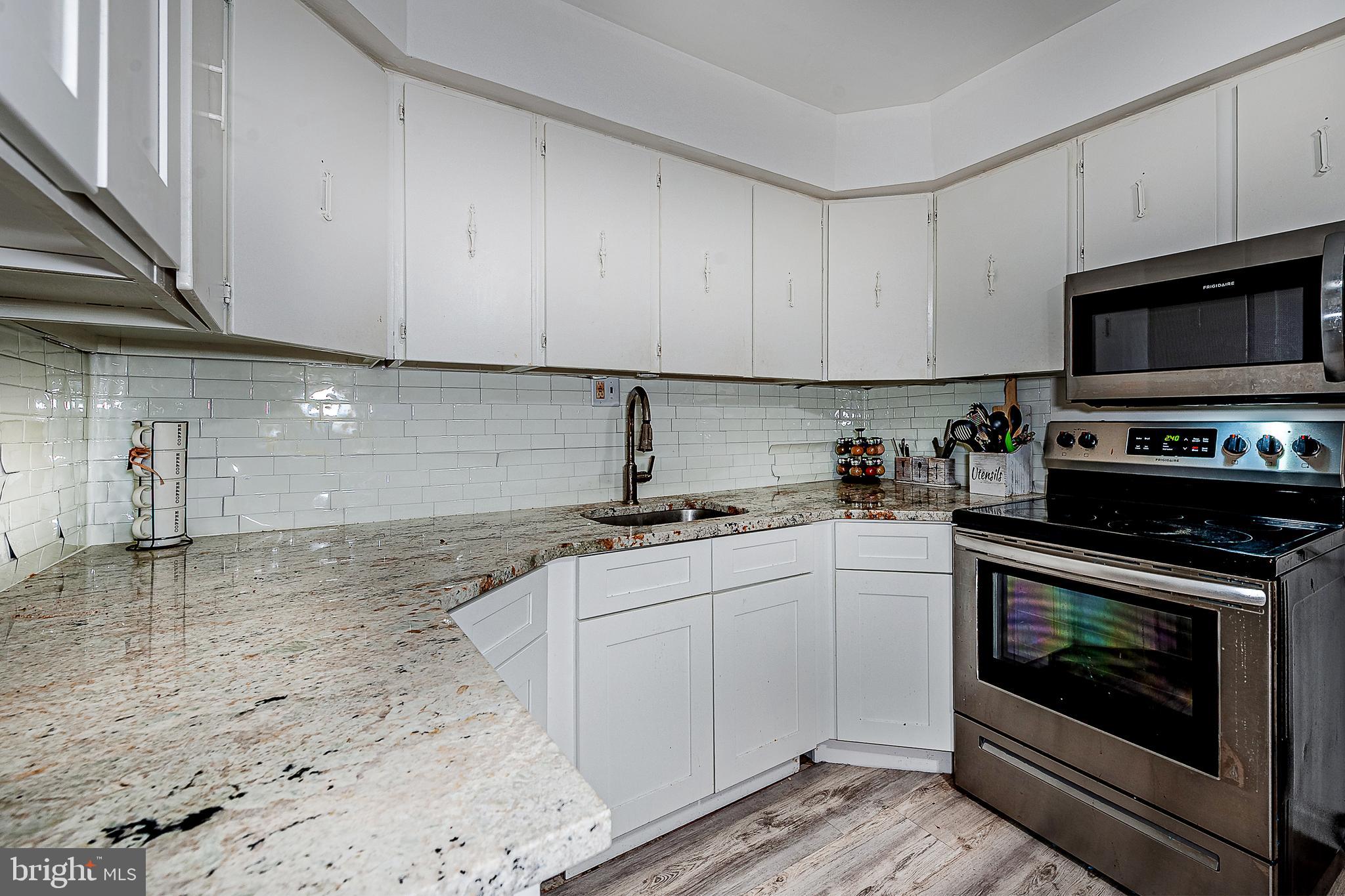 808 Winding Way Westville, NJ 08093 - Photo 9 of 14 a kitchen with granite countertop a stove sink and cabinets