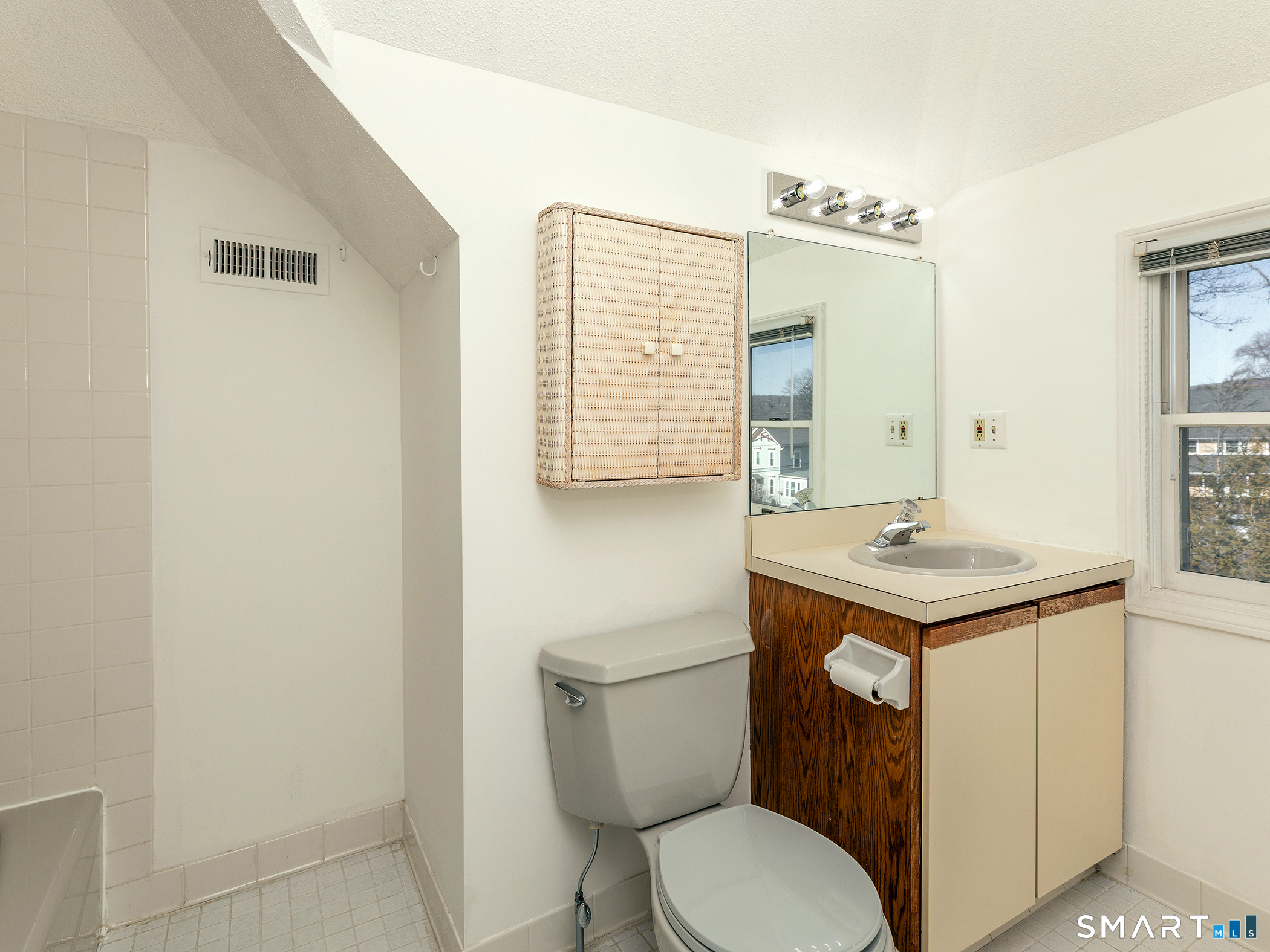 68 Wilson Avenue, Unit 105 Torrington, CT 06790 - Photo 15 of 24 a bathroom with a sink toilet and mirror