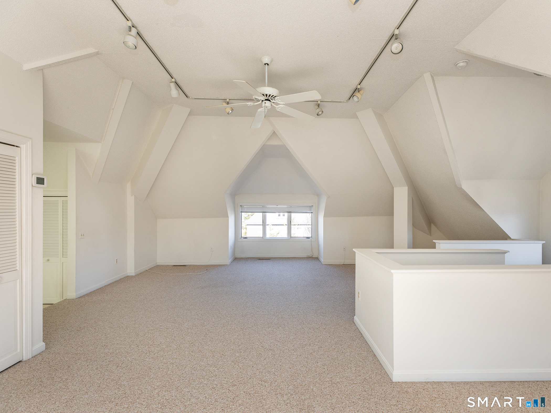 68 Wilson Avenue, Unit 105 Torrington, CT 06790 - Photo 6 of 24 an empty room with windows and fan
