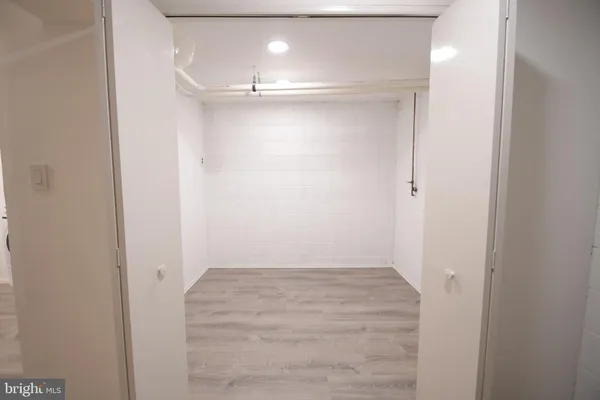 a view of a room with wooden floor