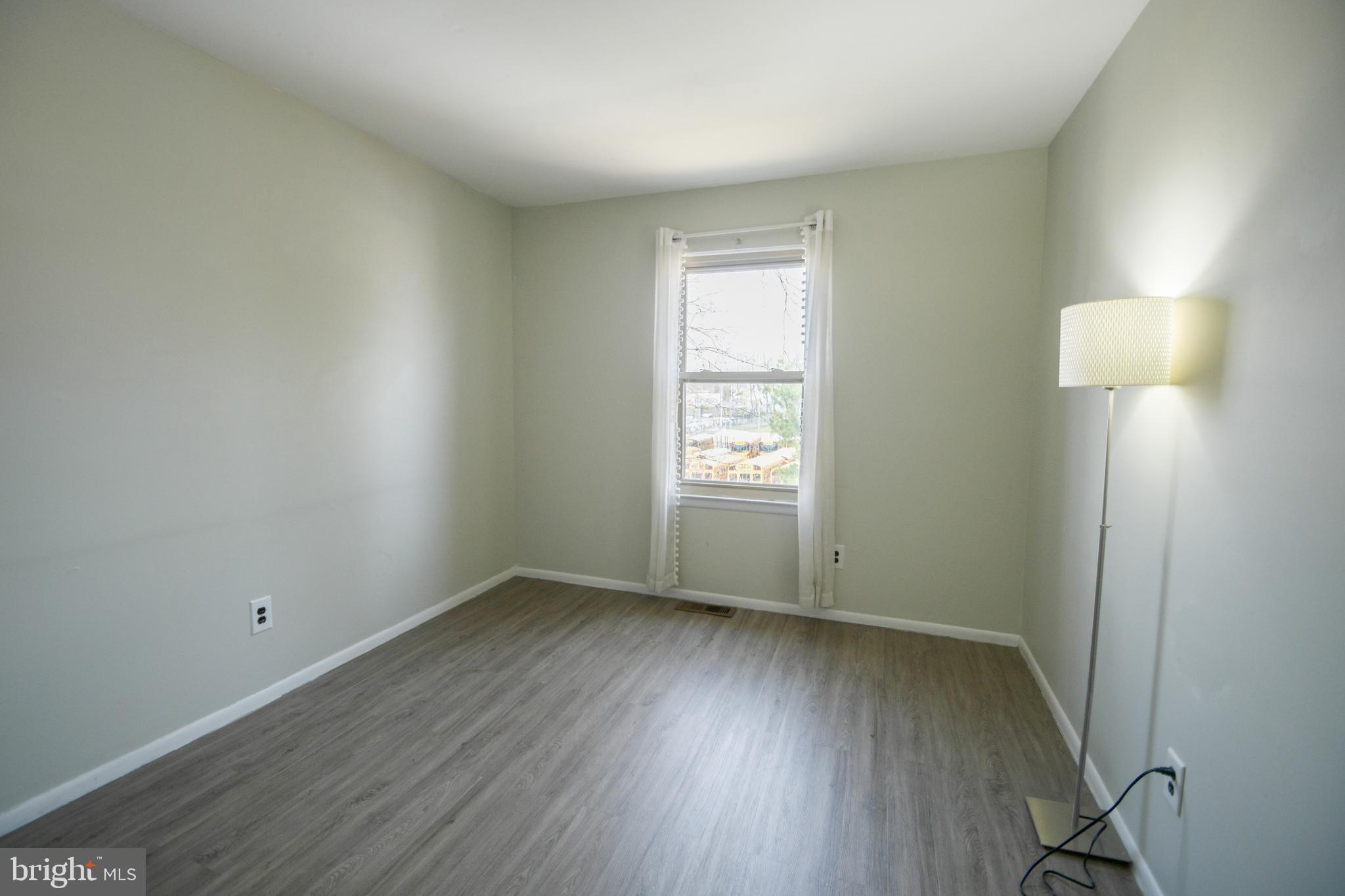 617 St Anthony Lane Upper Darby, PA 19082 - Photo 16 of 26 an empty room with wooden floor and windows