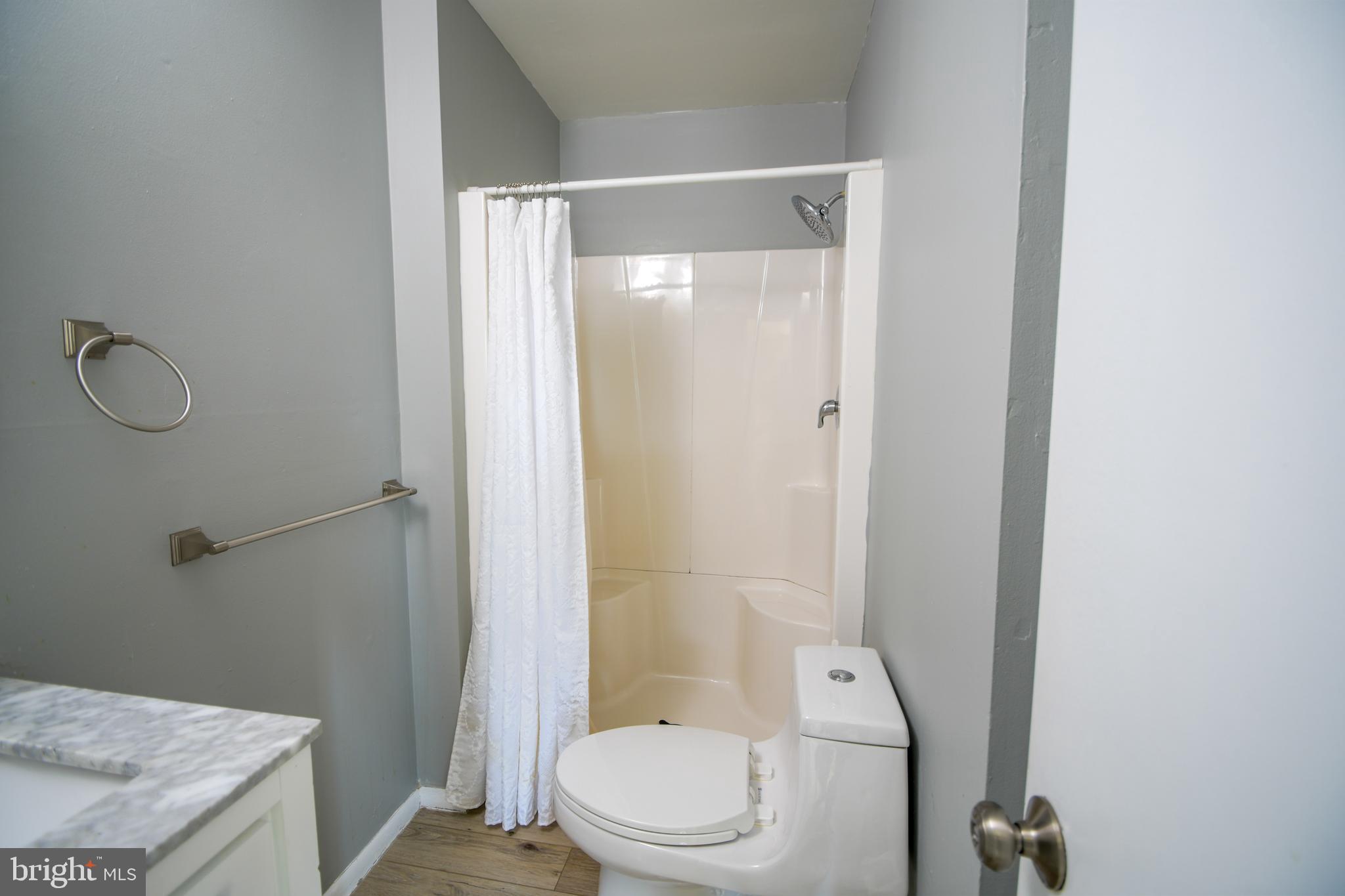 617 St Anthony Lane Upper Darby, PA 19082 - Photo 23 of 26 a bathroom with a granite countertop bathtub shower sink vanity and toilet
