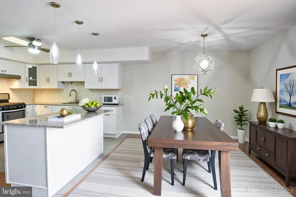 a kitchen with a table and chairs in it