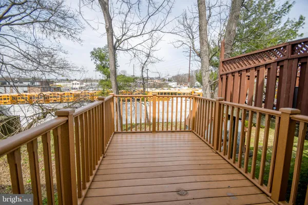 a view of a balcony with wooden floor and fence