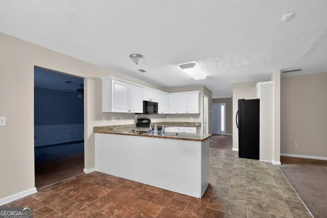 a kitchen with stainless steel appliances a refrigerator and a stove top oven