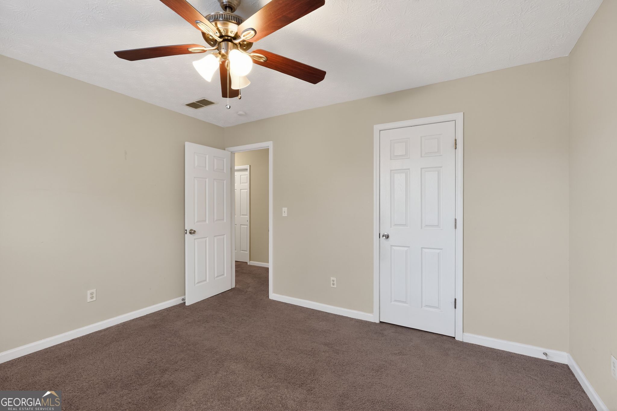 6463 Castle Ct Way Lithonia, GA 30058 - Photo 21 of 35 a view of an empty room and chandelier fan