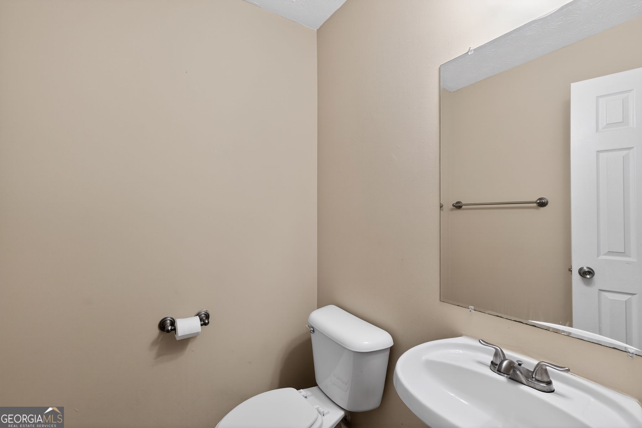 6463 Castle Ct Way Lithonia, GA 30058 - Photo 24 of 35 a white toilet sitting next to a bathroom sink