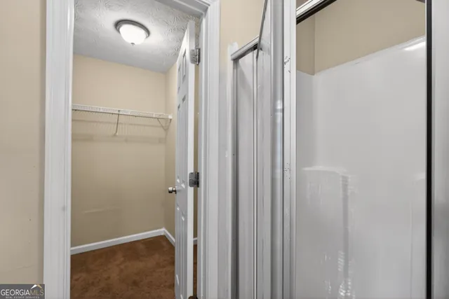 a bathroom with a shower and a glass door