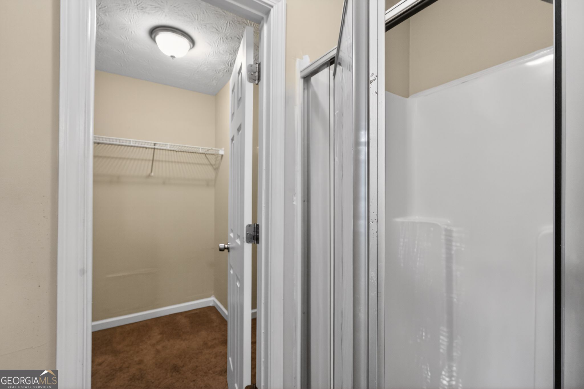 6463 Castle Ct Way Lithonia, GA 30058 - Photo 26 of 35 a bathroom with a shower and a glass door