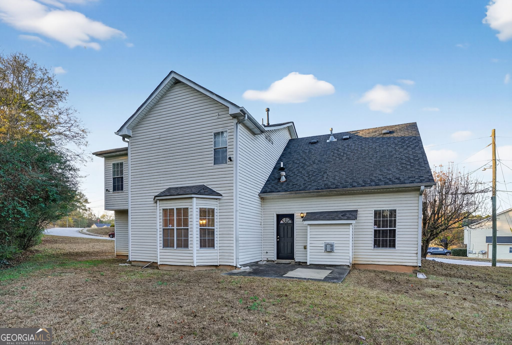 6463 Castle Ct Way Lithonia, GA 30058 - Photo 31 of 35 a front view of a house with a yard