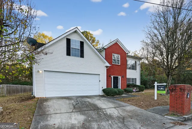 a front view of a house with yard