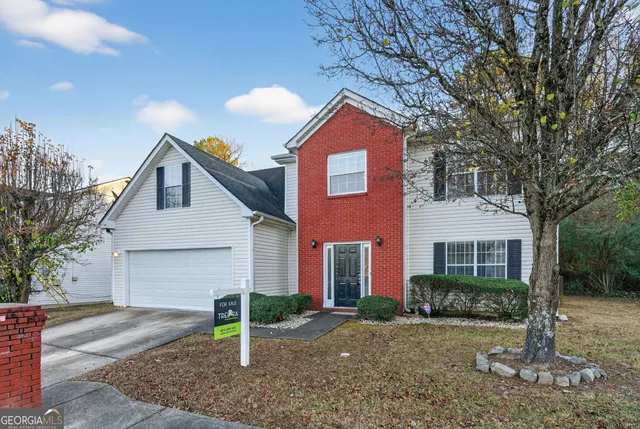a front view of a house with yard