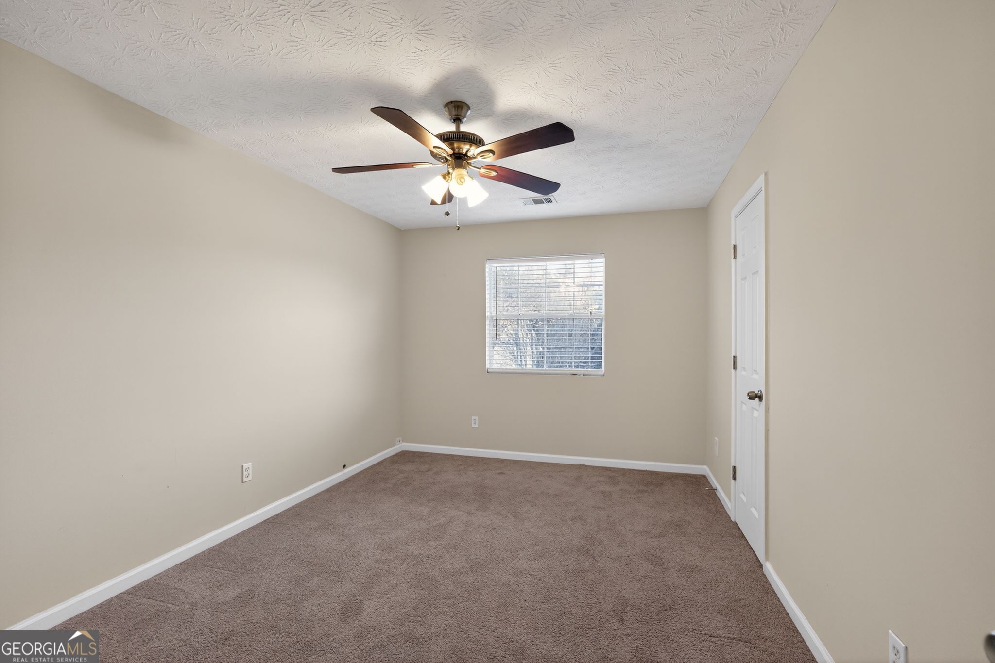 6463 Castle Ct Way Lithonia, GA 30058 - Photo 10 of 35 an empty room with a window and a fan