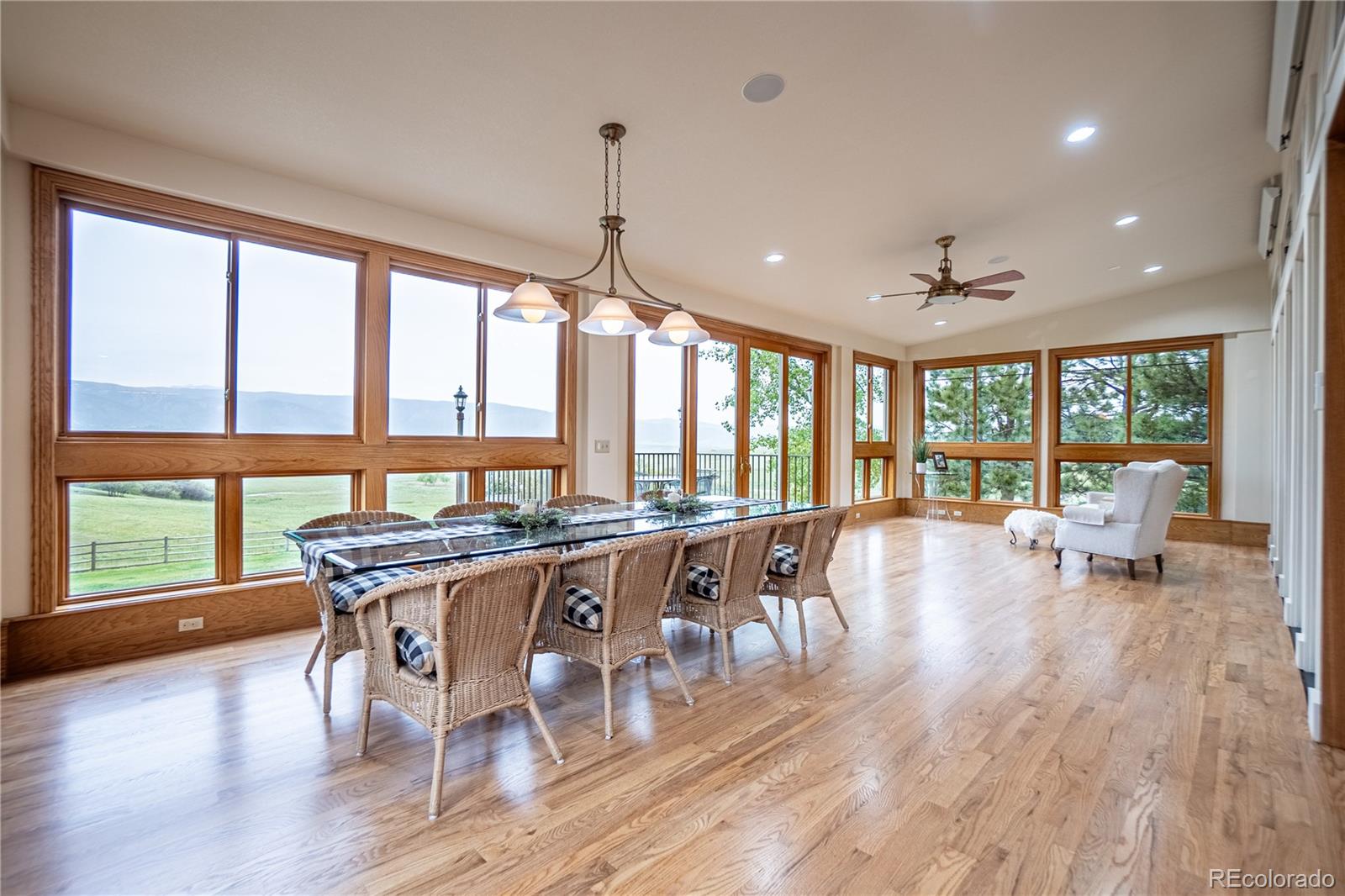 3282 Tomah Road Larkspur, CO 80118 - Photo 11 of 35 a view of a dining room with furniture window and wooden floor