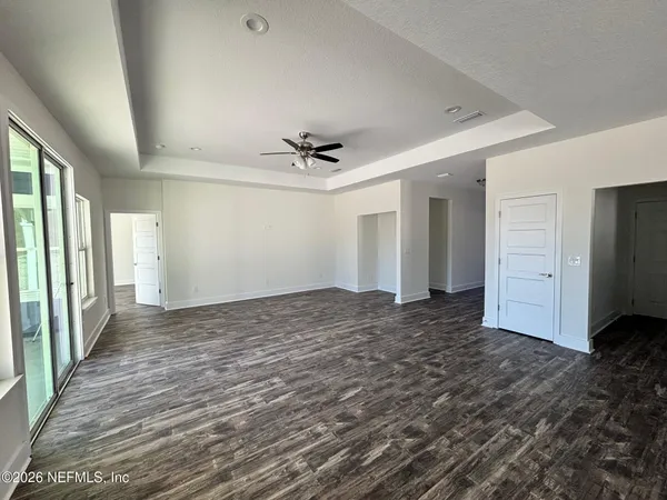 a view of a livingroom with a ceiling fan and window