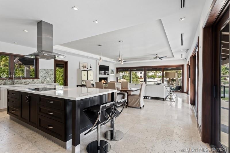1047 Mariner Drive Key Biscayne, FL 33149 - Photo 9 of 15 a large kitchen with a table and chairs in it
