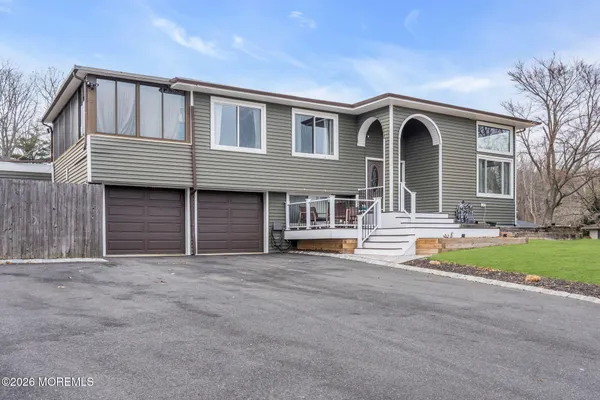 a front view of a house with outdoor seating and yard