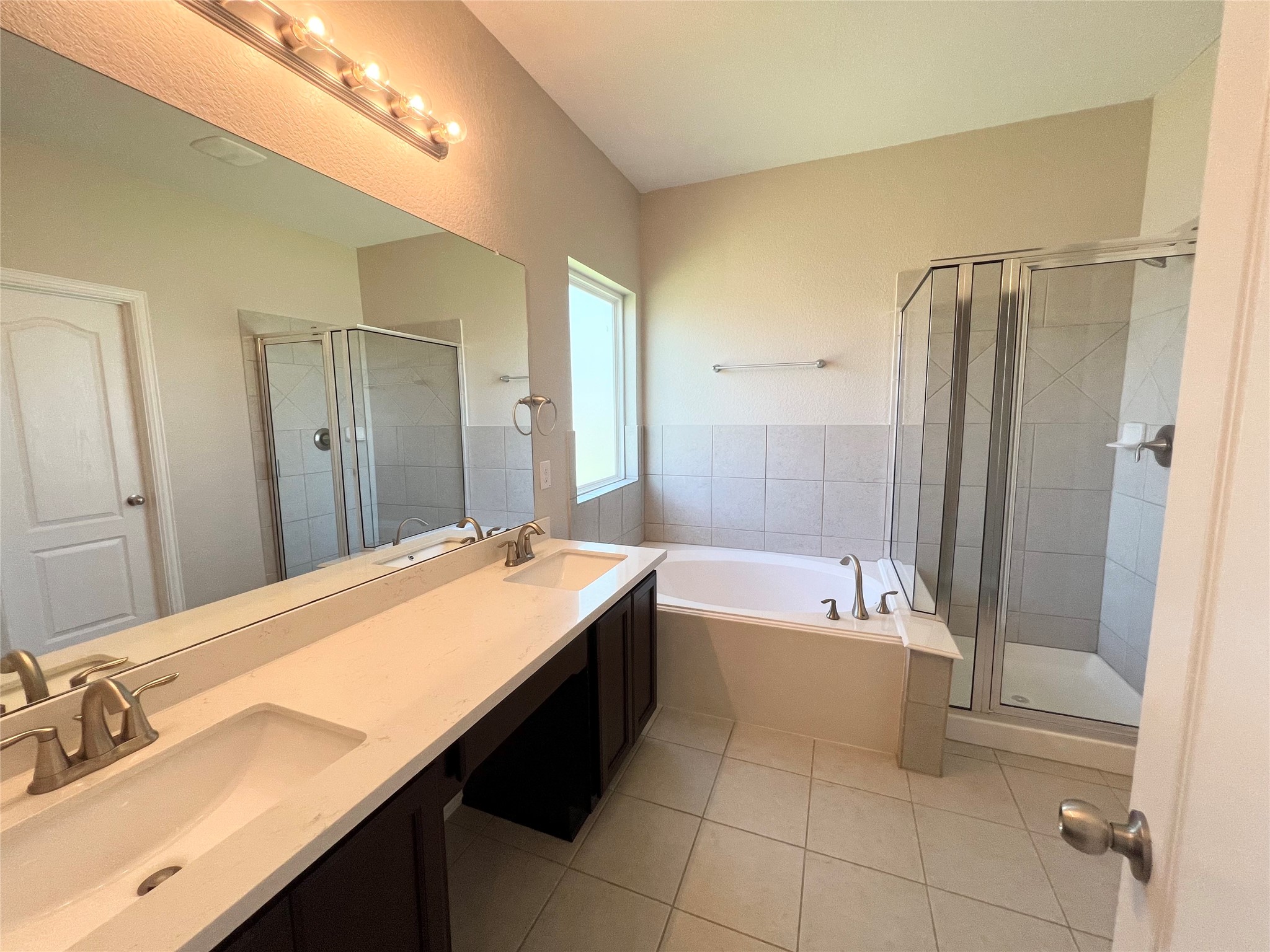 1507 Bella Garden Spring, TX 77373 - Photo 13 of 22 a spacious bathroom with a bathtub shower sink vanity and a mirror