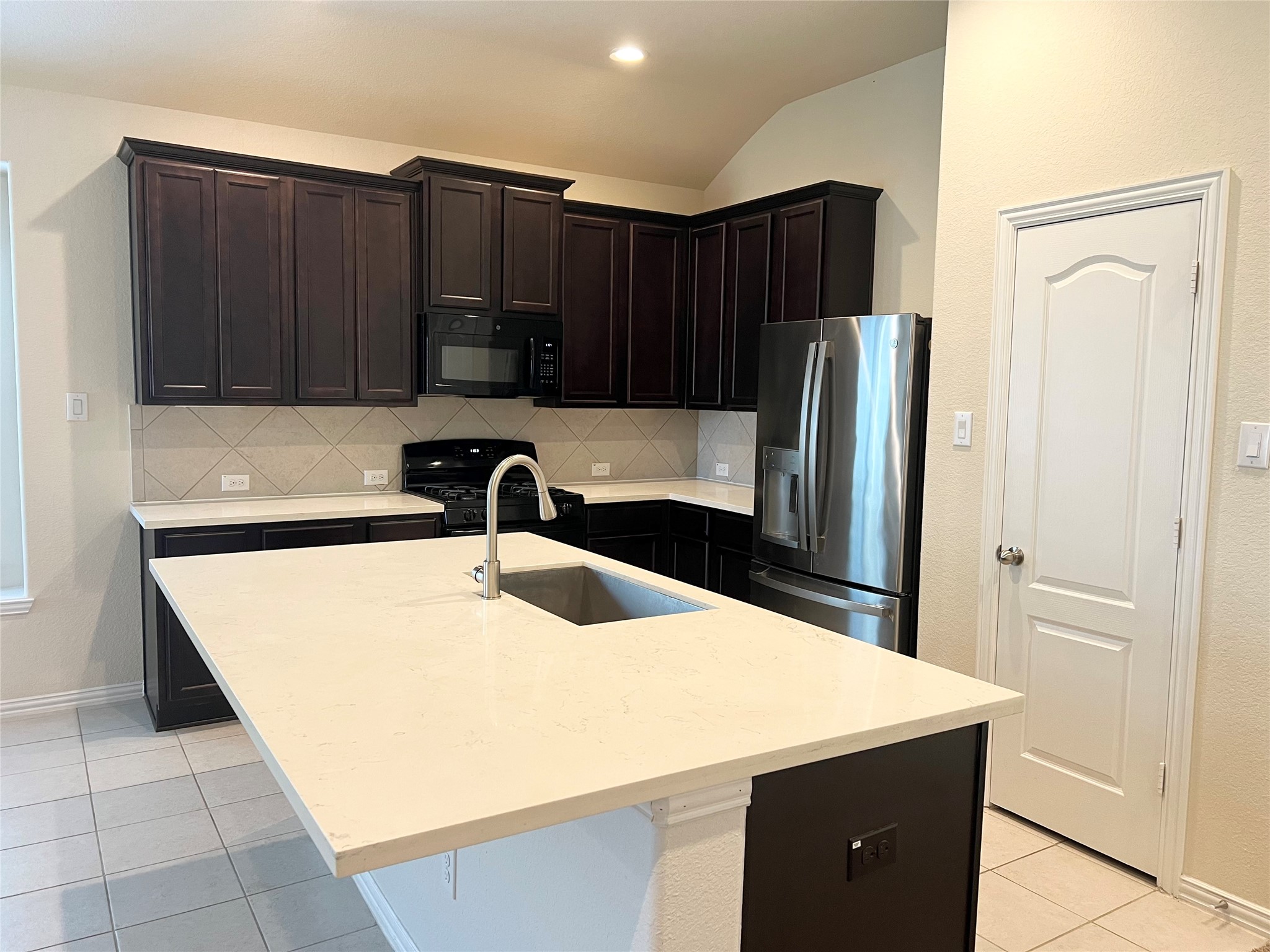 1507 Bella Garden Spring, TX 77373 - Photo 7 of 22 a kitchen with stainless steel appliances a refrigerator and a sink
