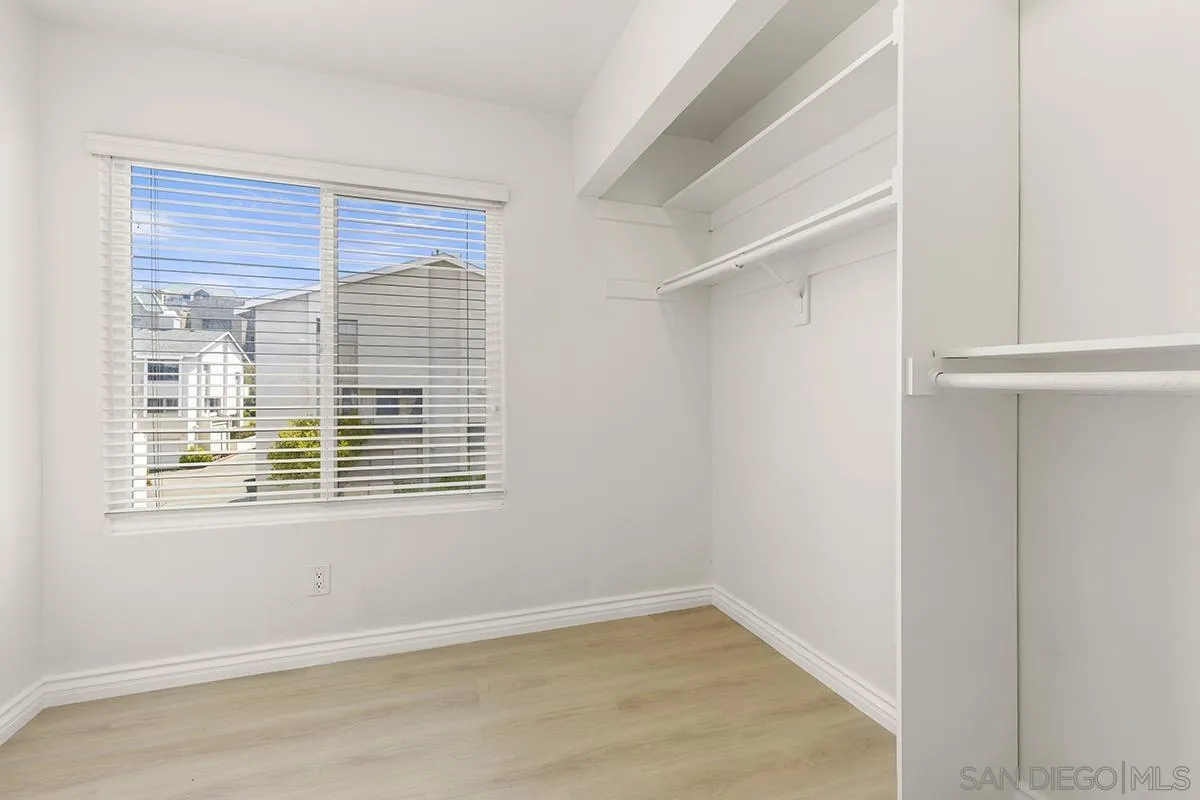4028 Mahaila Avenue, Unit C San Diego, CA 92122 - Photo 21 of 34 a view of an empty room with wooden floor and a window