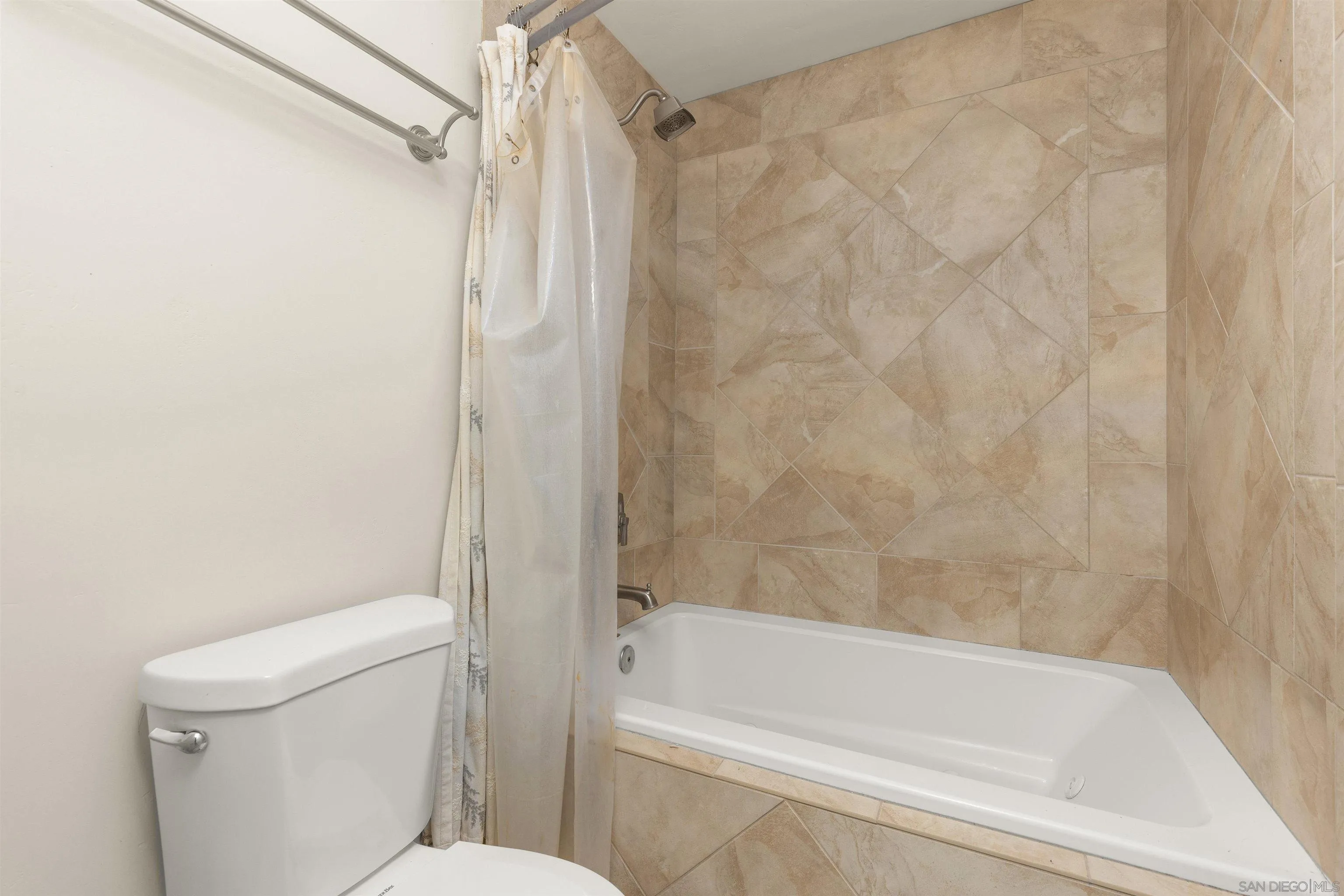 4028 Mahaila Avenue, Unit C San Diego, CA 92122 - Photo 23 of 34 a bathroom with a bathtub and a toilet