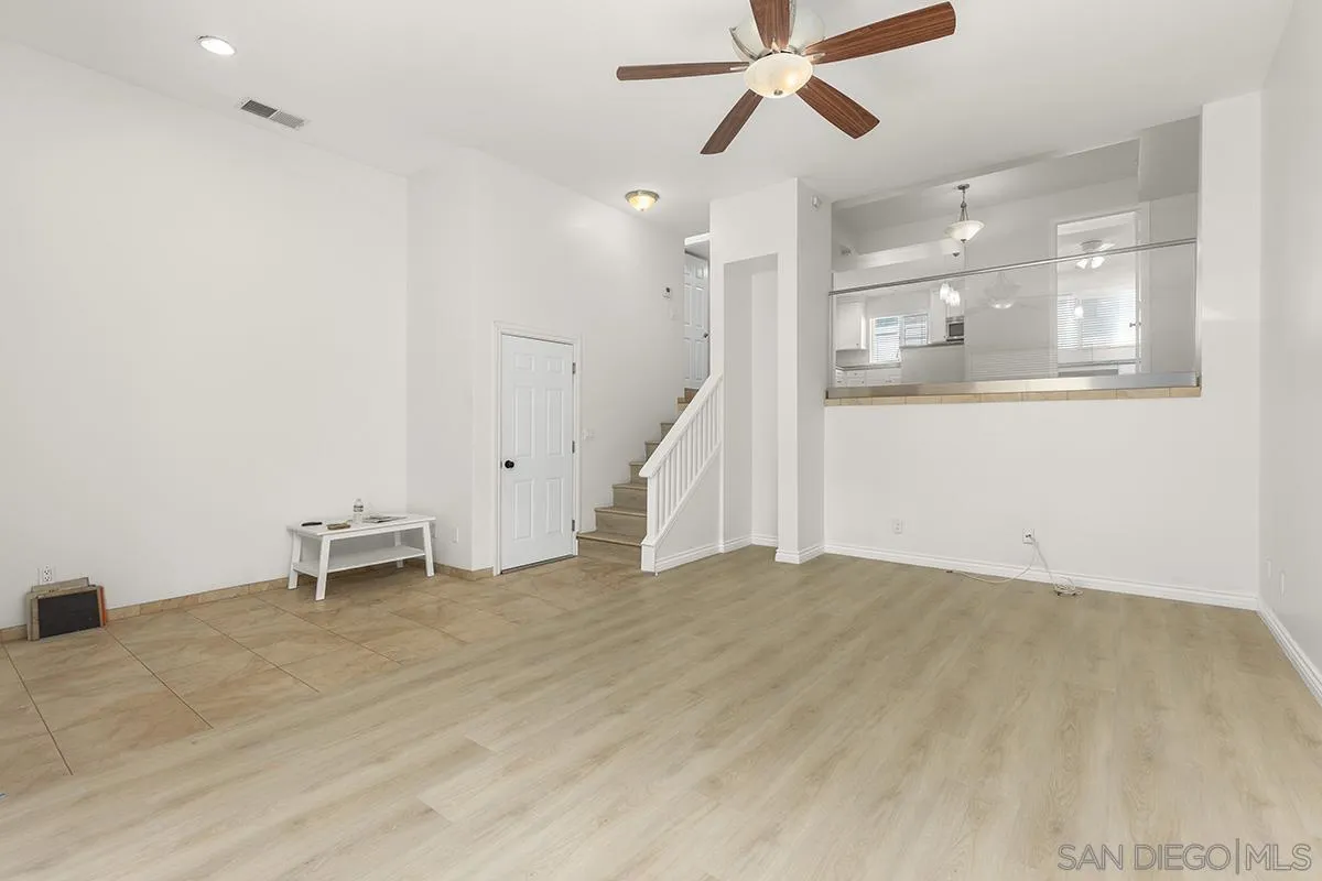 4028 Mahaila Avenue, Unit C San Diego, CA 92122 - Photo 9 of 34 a view of an empty room with wooden floor and a window