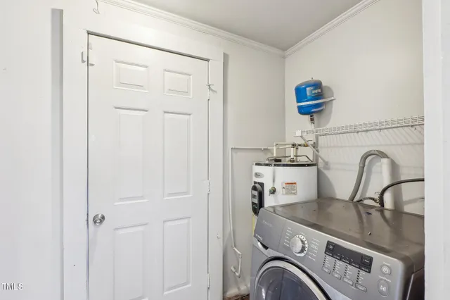 a close view of a sink and dishwasher in a white cabinet