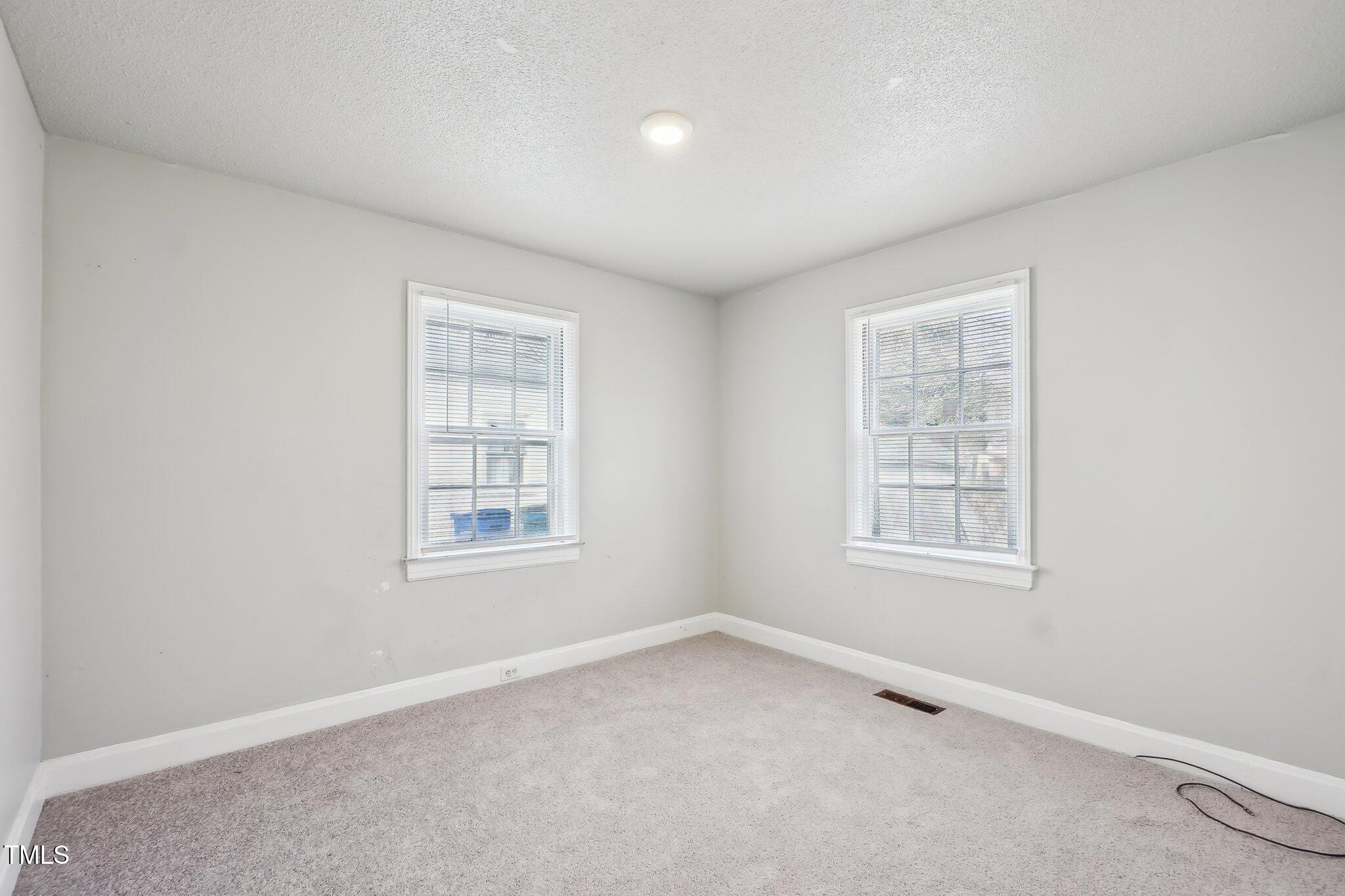 115 Higbee Street Durham, NC 27704 - Photo 7 of 14 an empty room with a window