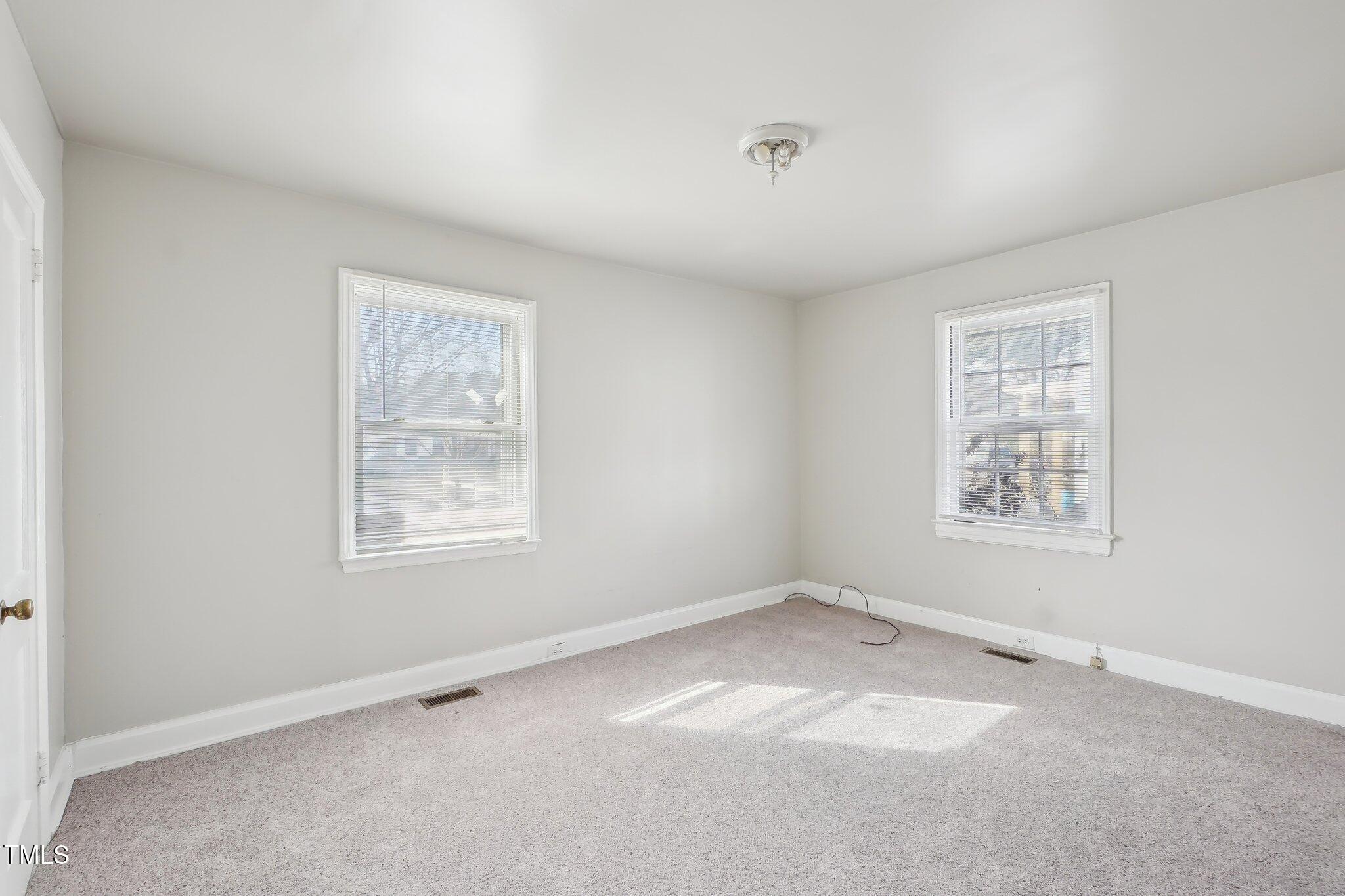 115 Higbee Street Durham, NC 27704 - Photo 9 of 14 an empty room with a window