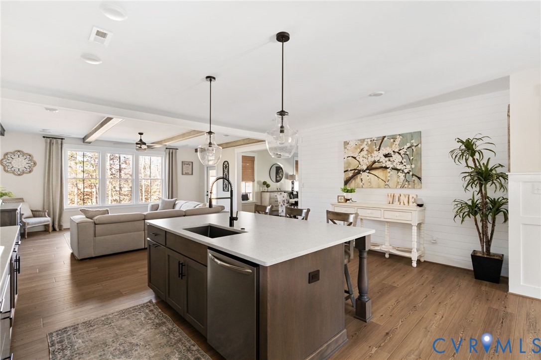 8614 Terroir Lane New Kent, VA 23124 - Photo 11 of 42 a kitchen with stainless steel appliances granite countertop a sink stove and wooden floor