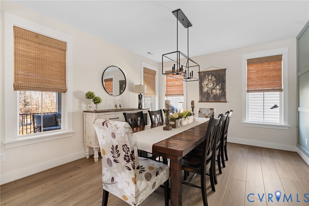 8614 Terroir Lane New Kent, VA 23124 - Photo 13 of 42 a view of a dining room with furniture window and wooden floor