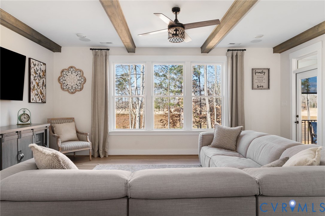 8614 Terroir Lane New Kent, VA 23124 - Photo 16 of 42 a living room with furniture and a large window
