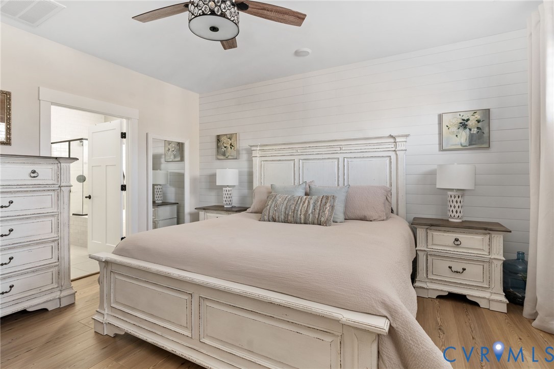 8614 Terroir Lane New Kent, VA 23124 - Photo 20 of 42 a bedroom with a bed and a chandelier