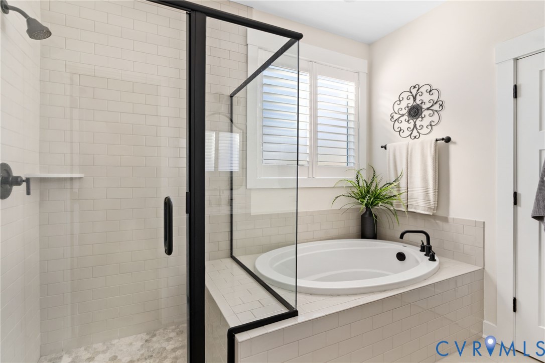 8614 Terroir Lane New Kent, VA 23124 - Photo 21 of 42 a bathroom with a tub and a shower