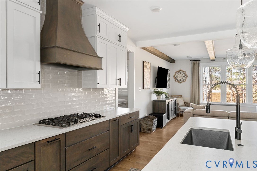 8614 Terroir Lane New Kent, VA 23124 - Photo 10 of 42 a kitchen with stainless steel appliances granite countertop a sink a stove and a refrigerator