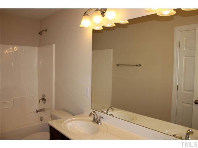 2804 Bending Tree Court Raleigh, NC 27613 - Photo 19 of 25 Custom Stained Cabinets with Cultured Marble Countertop, Frameless Vanity Mirror. Bathroom