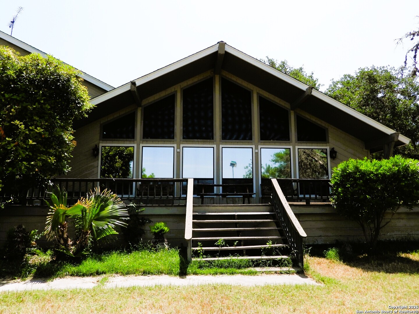 3078 Goat Hill Road Lakehills, TX 78063 - Photo 1 of 38 a front view of a house with garden