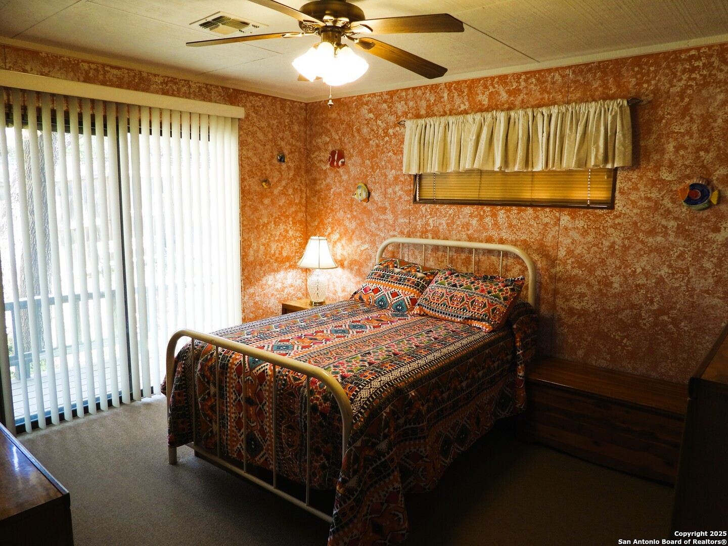 3078 Goat Hill Road Lakehills, TX 78063 - Photo 15 of 38 a bed sitting in a bedroom next to a window
