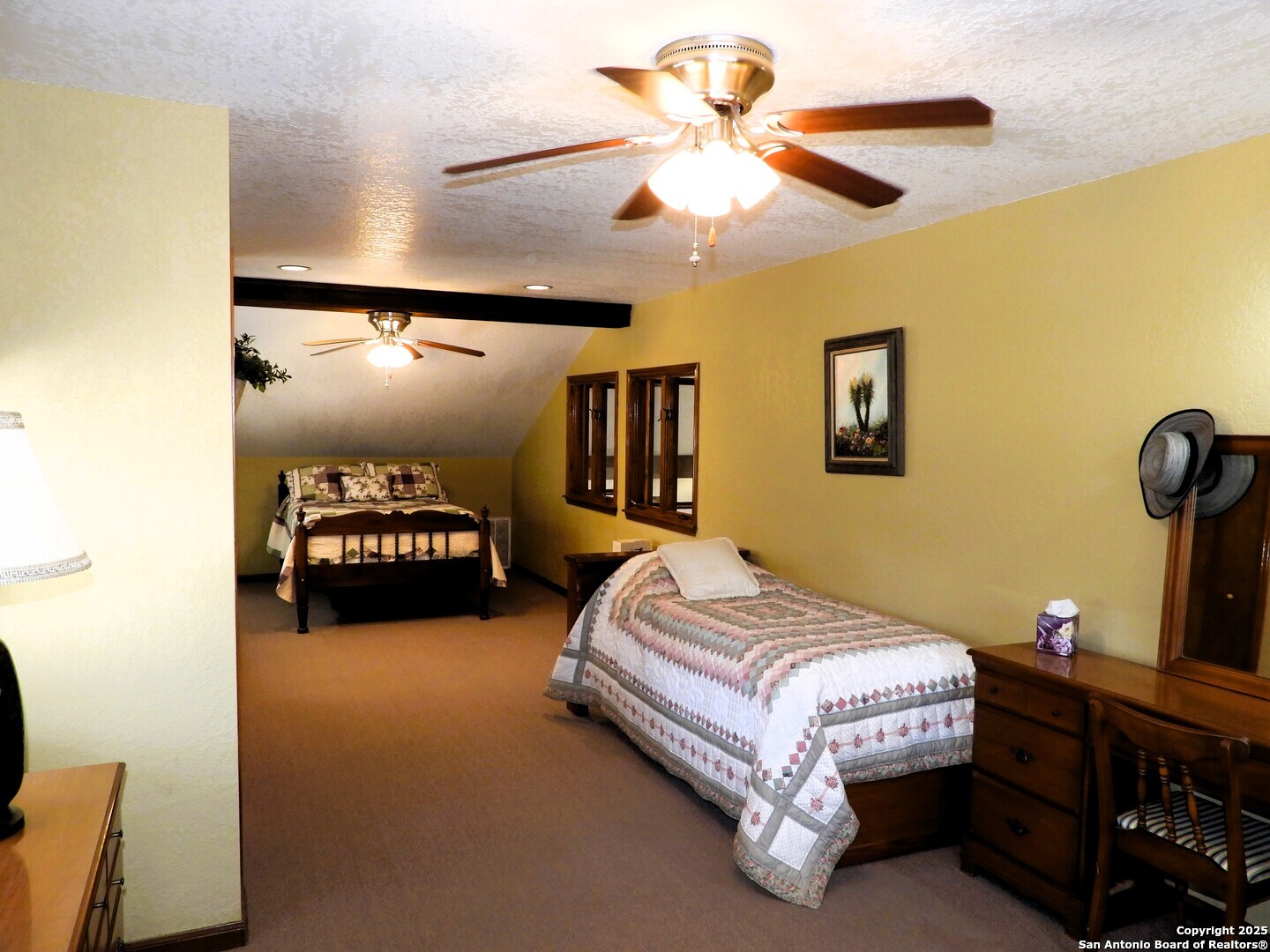 3078 Goat Hill Road Lakehills, TX 78063 - Photo 22 of 38 a spacious bedroom with a bed and dresser