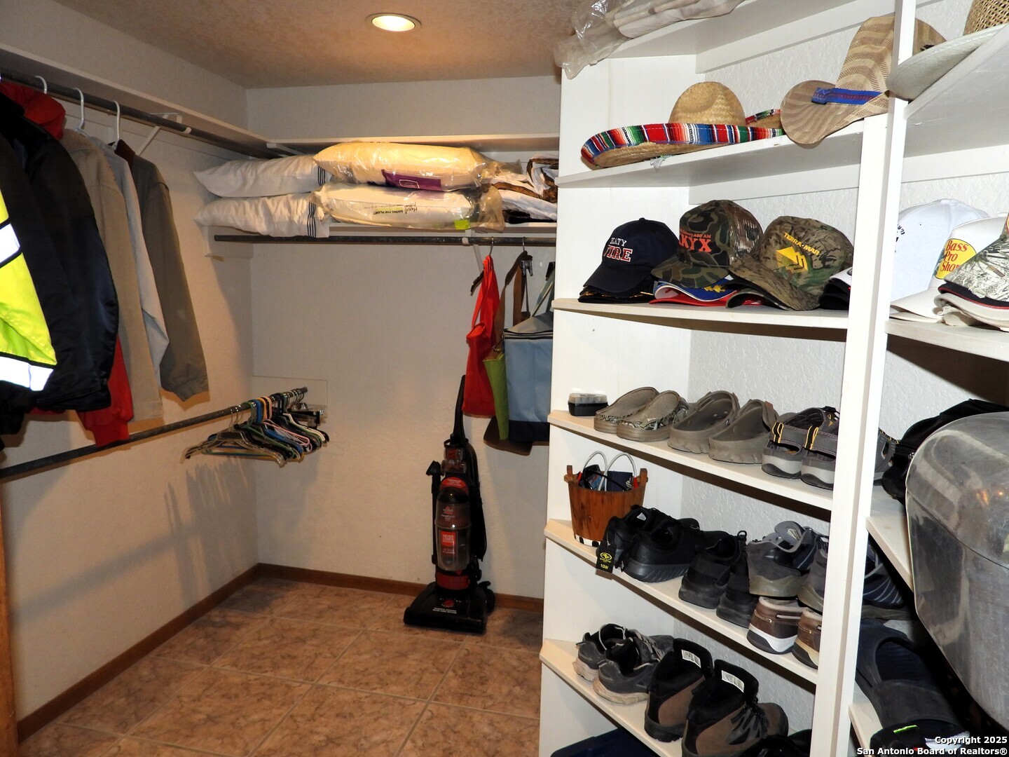3078 Goat Hill Road Lakehills, TX 78063 - Photo 30 of 38 a view of walk in closet with clothes and shoes