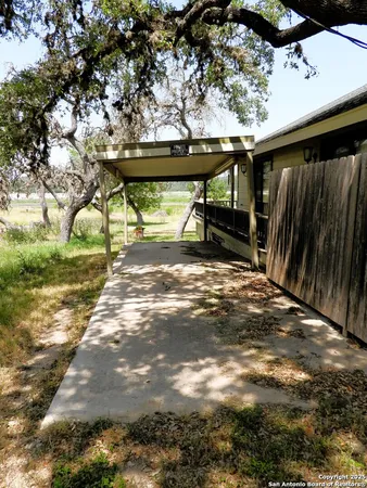 a view of backyard with wooden fence