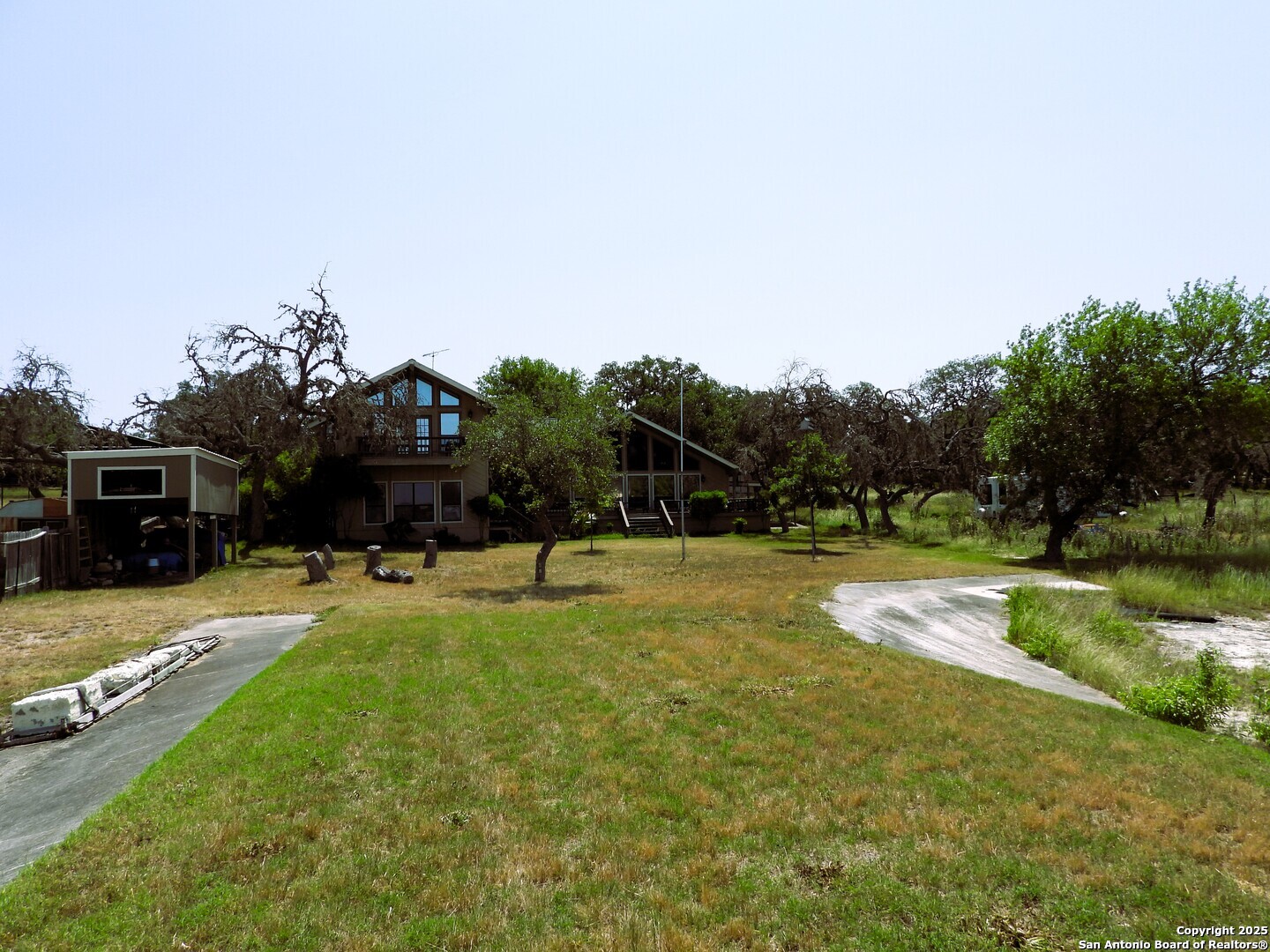 3078 Goat Hill Road Lakehills, TX 78063 - Photo 36 of 38 a swimming pool with lots of tress in it