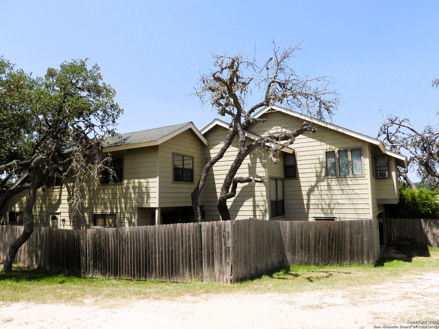3078 Goat Hill Road Lakehills, TX 78063 - Photo 4 of 38 a front view of a house with a yard