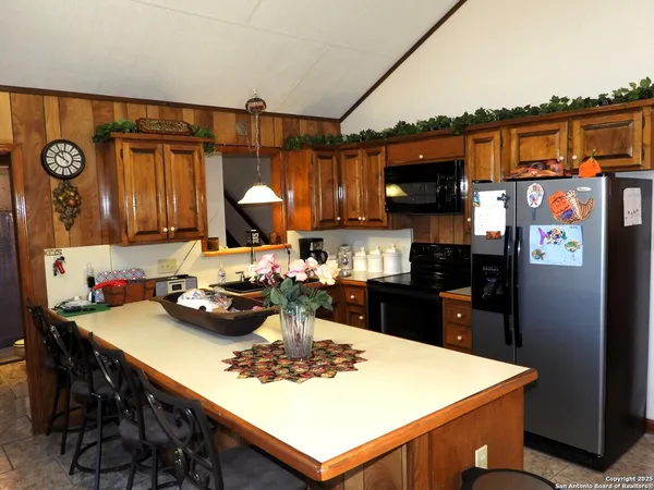 a kitchen with a sink a stove and cabinets