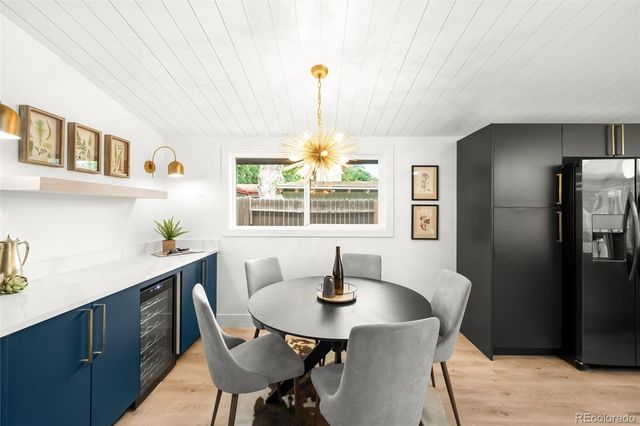 a dining room with furniture a chandelier and window