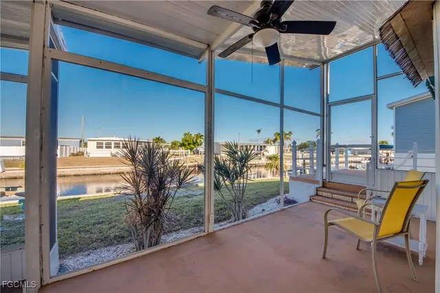 a view of a porch with furniture and a yard