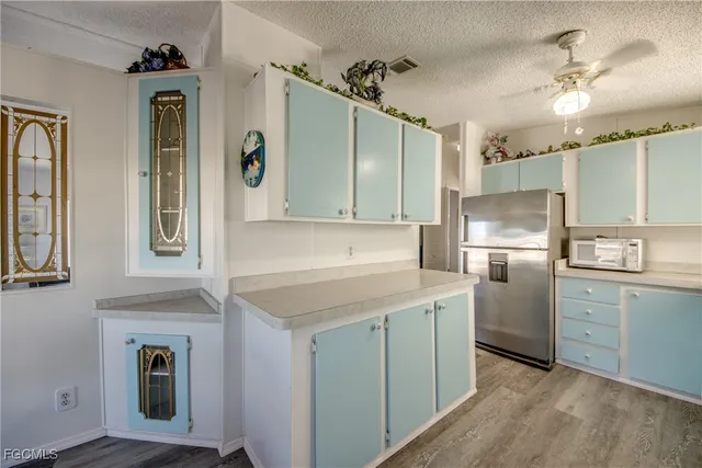 a kitchen with cabinets and stainless steel appliances