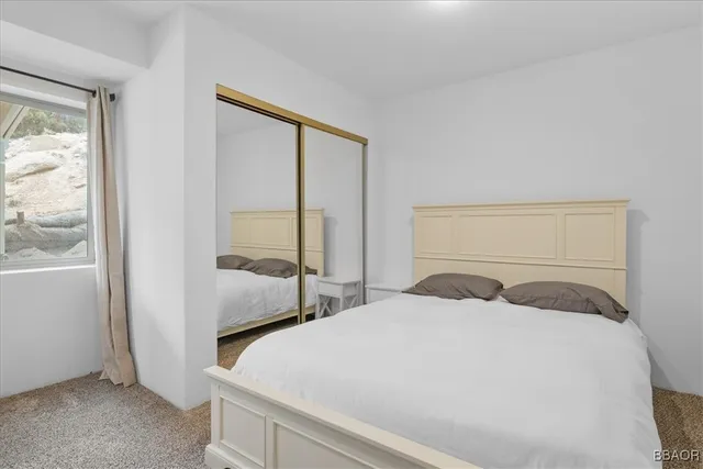 a bedroom with a large bed and a large window