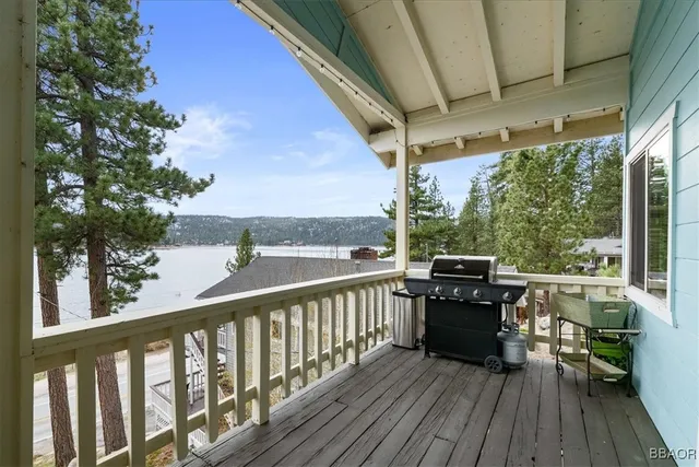 a view of balcony with wooden floor and seating space