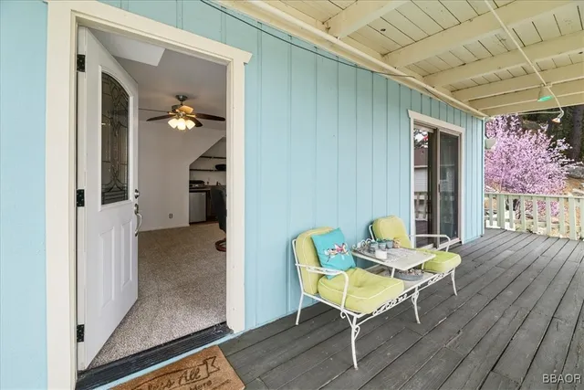 a view of a hallway with wooden floor and a potted plant